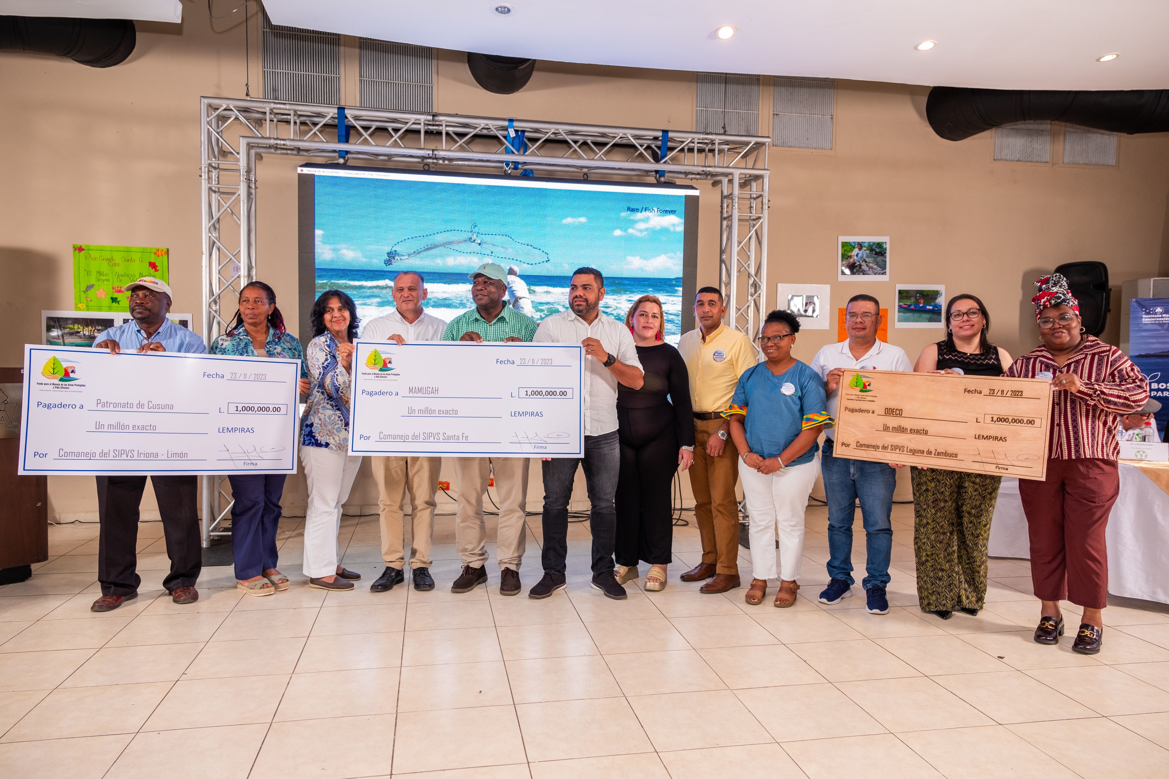 mayors and fishers pictured with a giant check