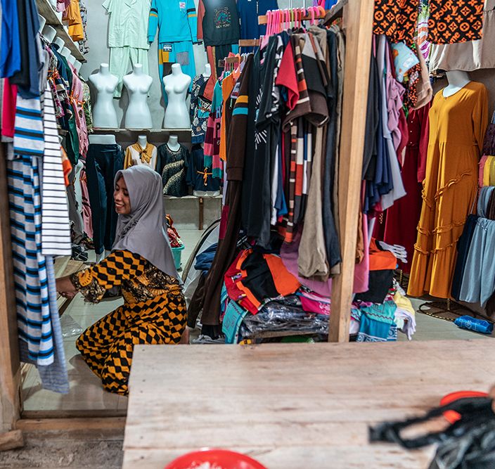 Ibu Rosmiati in her clothing stall.