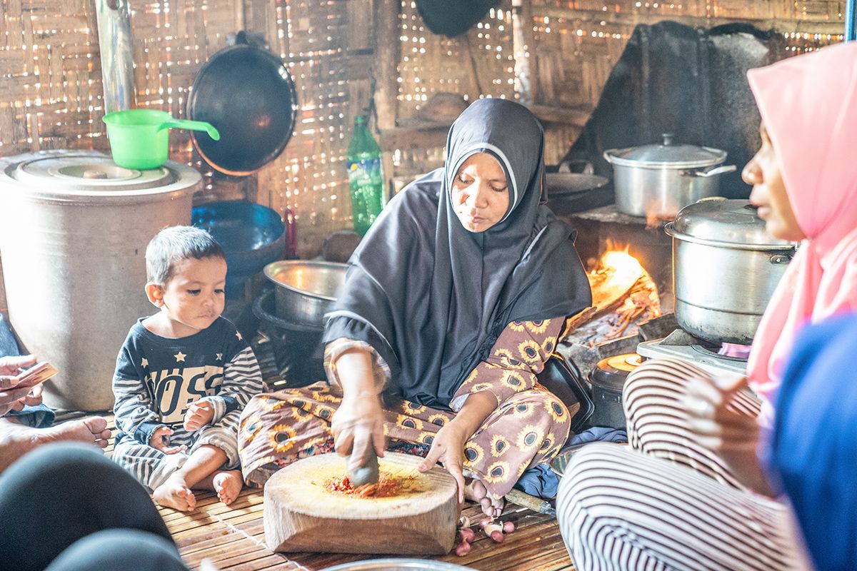 Nurlini cooking for her family.
