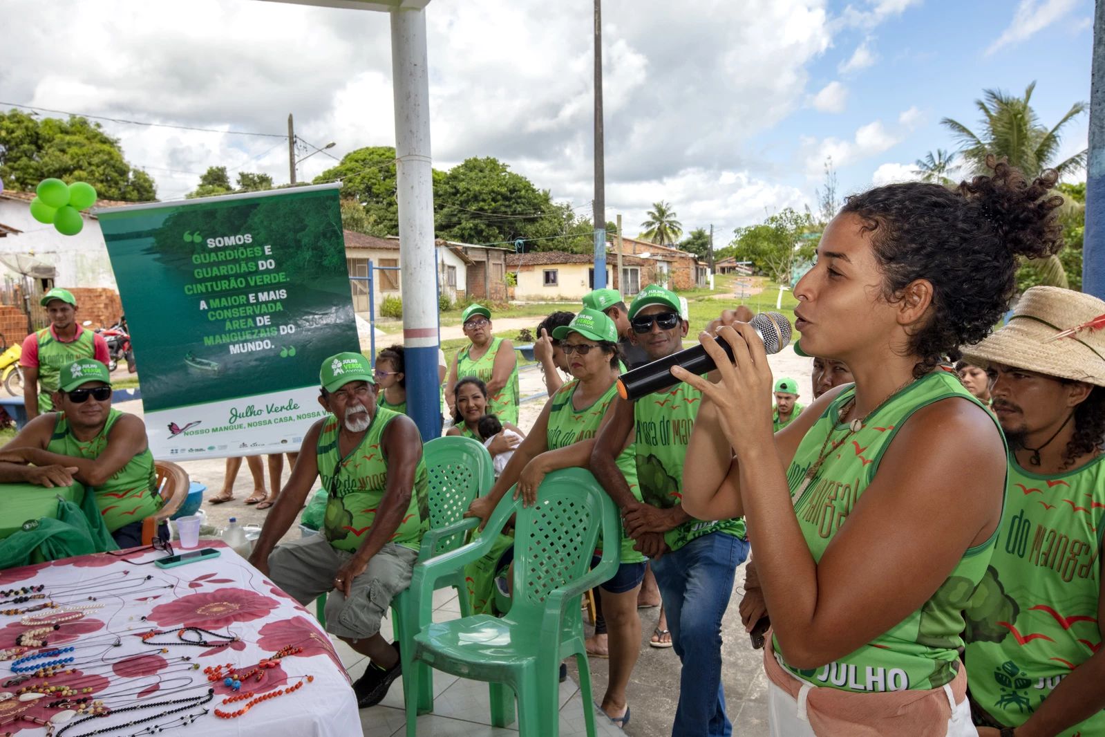 Rare's Bruna Martins speaking at a Green July campaign event in the Cafezal community. The 2022 Green July campaign mobilized the fishing communities of the Marine Extractive Reserves of Pará to execute actions and share information on the importance of mangrove conservation. It took place in 13 municipalities and engaged more than 5,000 people in face-to-face and virtual meetings.